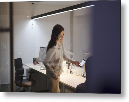Unemployment Office Metal Print featuring the photograph Woman sharing idea on smart phone with coworker in office by FangXiaNuo