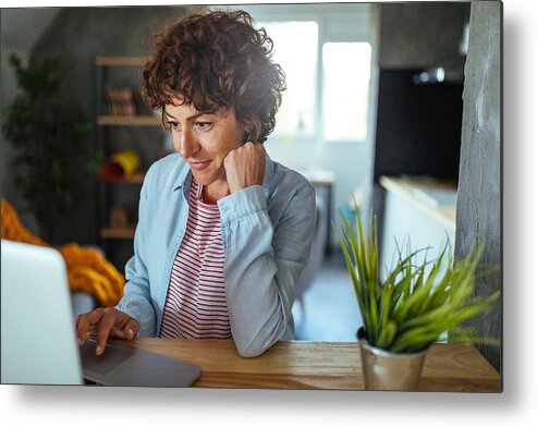 Internet Metal Print featuring the photograph Woman using a computer by Mixetto