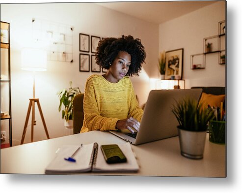 Expertise Metal Print featuring the photograph Young African American businesswoman at home office, working late by Drazen_