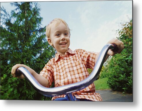 Part Of A Series Metal Print featuring the photograph Young Blond Boy Riding a Tricycle in a Park by Darryl Leniuk