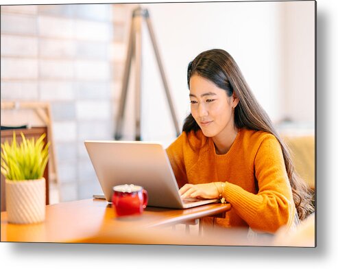 Electronic Banking Metal Print featuring the photograph Young woman using laptop comfortably at home by Recep-bg