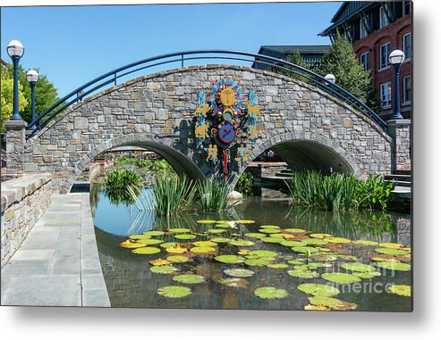 Carroll Creek Metal Print featuring the photograph Zodiac inspired clock on a stone bridge in Carroll Creek Park in Frederick Maryland by William Kuta