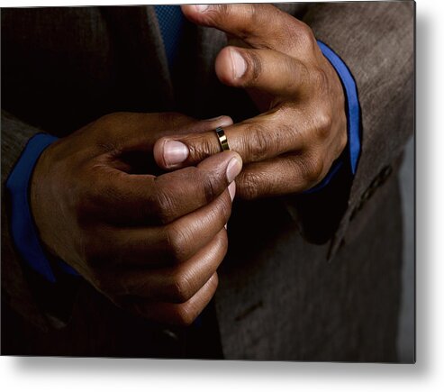 Hiding Metal Print featuring the photograph Business man putting on wedding band by Le Club Symphonie