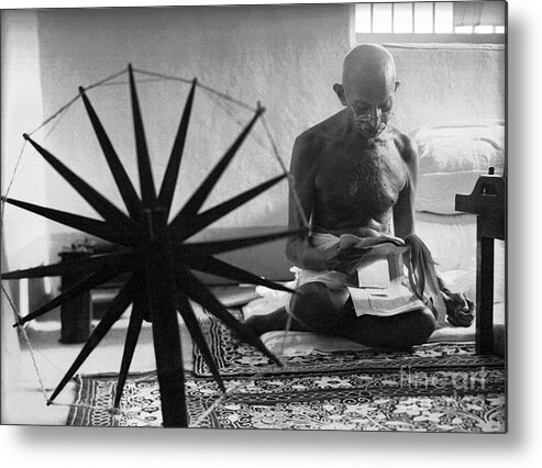 Gandhi At His Spinning Wheel Metal Print featuring the photograph Gandhi at his Spinning Wheel by Celestial Images