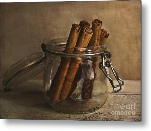 Cinnamon Metal Print featuring the photograph Cinnamon sticks in a glass jar by Elena Nosyreva
