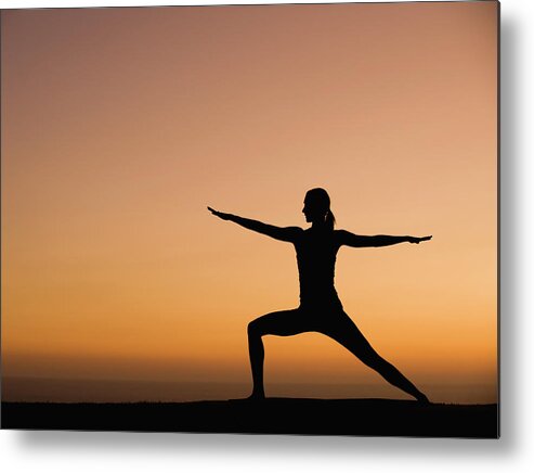 Tranquility Metal Print featuring the photograph Silhouette Of Woman Doing Yoga by Erik Isakson
