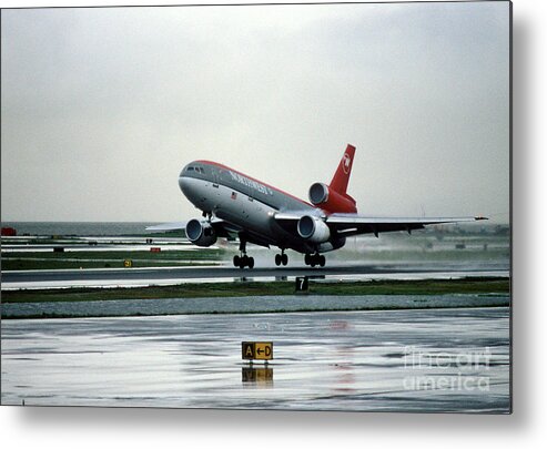 N154us Metal Print featuring the photograph Douglas DC-10-40 Taking Off in the Rain by Wernher Krutein