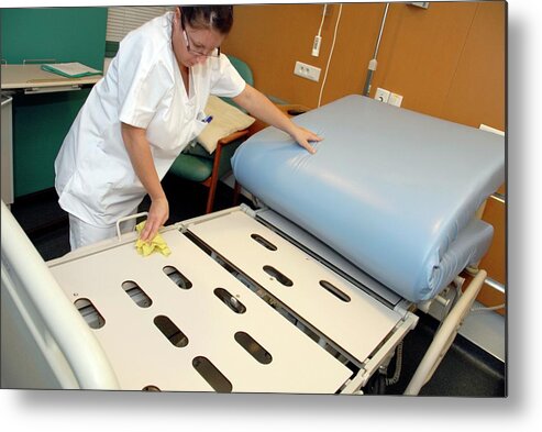 Equipment Metal Print featuring the photograph Nurse Cleaning Hospital Bed by Aj Photo/science Photo Library