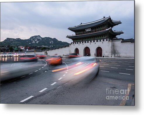 Ancient Metal Print featuring the photograph Traffic rushing in front of the Gyeongbokgung palace in Seoul by Didier Marti