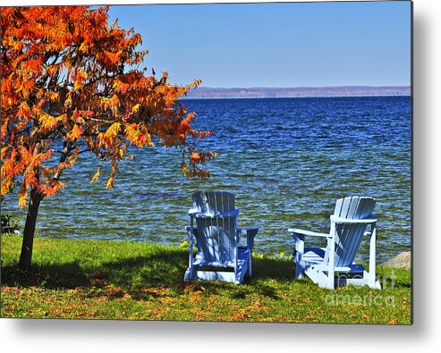 Lake Metal Print featuring the photograph Wooden chairs on autumn lake by Elena Elisseeva