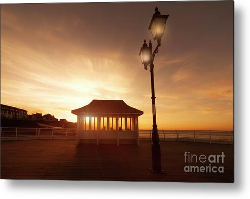 Norfolk Metal Print featuring the photograph Cromer pier in Norfolk England shelter at sunset by Simon Bratt