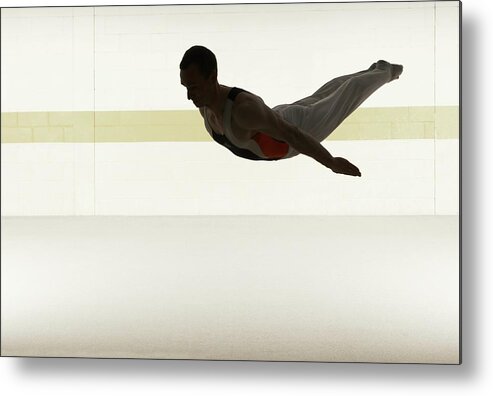 People Metal Print featuring the photograph Male Gymnast Performing Somersault In by Romilly Lockyer