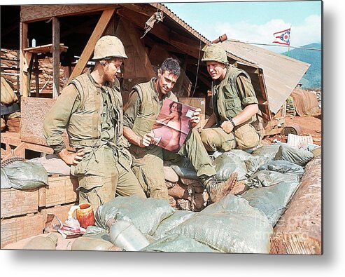 Vietnam War Metal Print featuring the photograph Marines Outside Bunker Admiring Pin-up by Bettmann