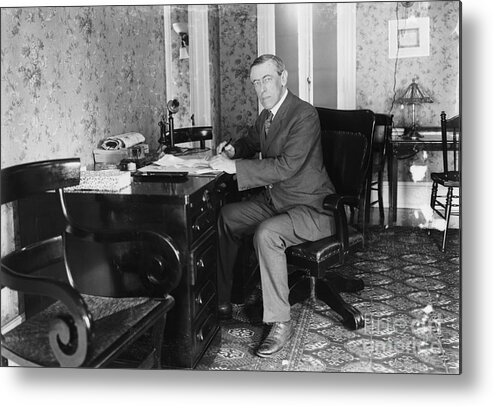 Woodrow Wilson Metal Print featuring the photograph Woodrow Wilson Seated At Desk by Bettmann