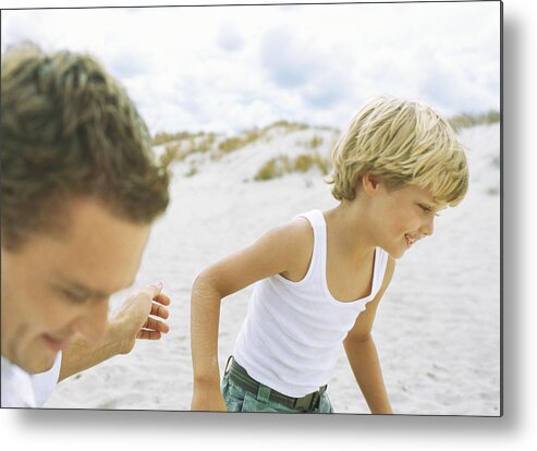 Young Men Metal Print featuring the photograph Boy and father running on beach by Sigrid Olsson
