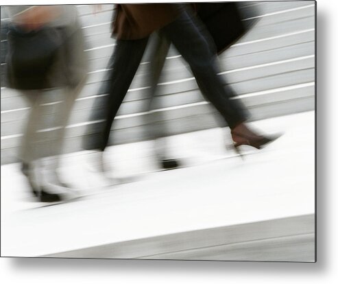 Working Metal Print featuring the photograph Business people walking in street, low section, blurred by Eric Audras