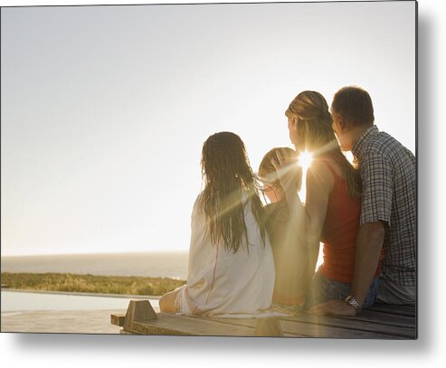 Mid Adult Women Metal Print featuring the photograph Family sitting on deck in afternoon sun by Sam Edwards