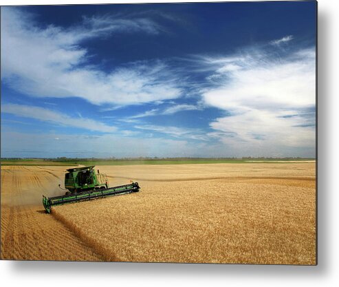 John Deere Metal Print featuring the photograph Full Hopper - John Deere combine harvesting wheat on rolling ND prairie by Peter Herman