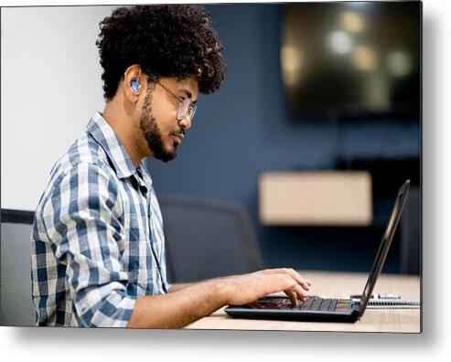 Adults Only Metal Print featuring the photograph Hearing impaired man working on laptop at office by Giselleflissak
