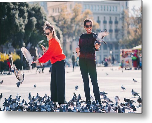White People Metal Print featuring the photograph Women traveling in Europe and feeding pigeons in Barcelona by Martin-dm