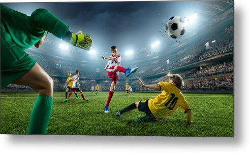 Soccer Uniform Metal Print featuring the photograph Soccer kids players scoring a goal. Goalkeeper tries to hit the ball by Aksonov