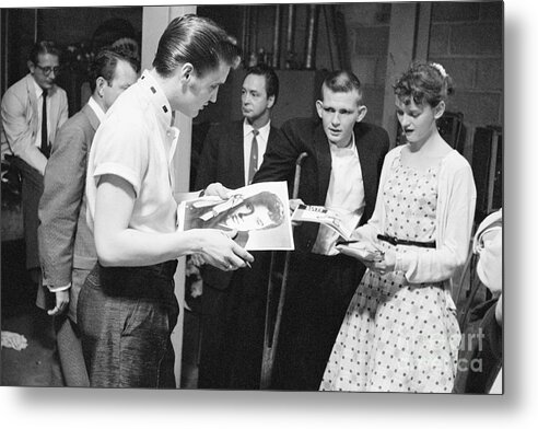 Elvis Presley Metal Print featuring the photograph Elvis Presley Backstage Signing Autographs for Fans 1956 by The Harrington Collection