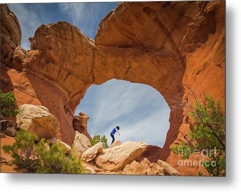 Arches Metal Print featuring the photograph Balancing under an Arch by Agnes Caruso