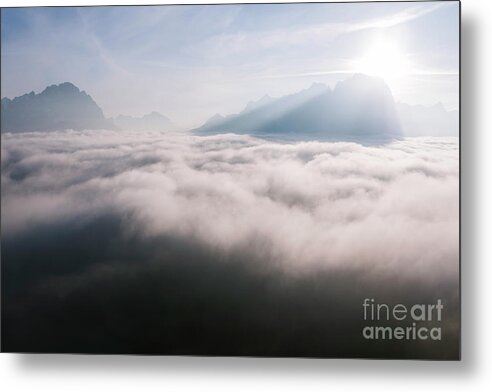 Above Metal Print featuring the photograph Aerial view of low clouds and mountain peak at sunrise by Matteo Colombo