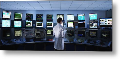 Information Medium Metal Print featuring the photograph Scientist monitoring computers in control room by Martin Barraud