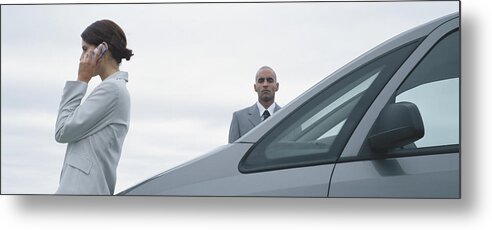 Bodyguard Metal Print featuring the photograph Woman and man in suits standing near car, man looking at camera, woman talking on cell phone by Matthieu Spohn
