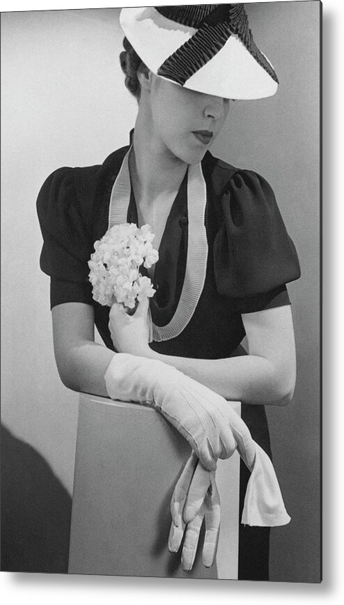 Fashion Metal Print featuring the photograph A Model Wearing A Crepe Dress And Straw Hat by Lusha Nelson