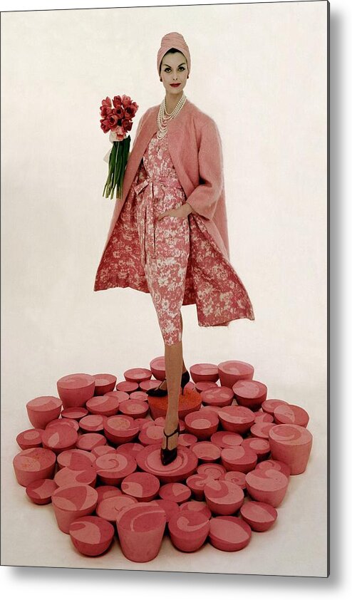 Fashion Metal Print featuring the photograph A Model Wearing A Matching Pink Outfit Holding by William Bell
