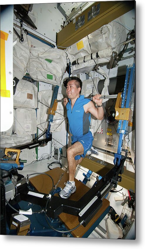 2014 Metal Print featuring the photograph Astronaut Exercising On The Iss by Nasa