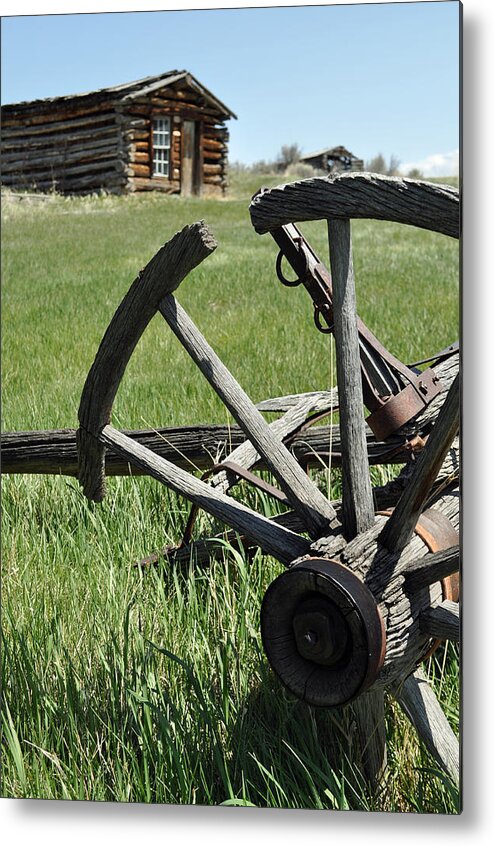 Montana Metal Print featuring the photograph Broken Wagon Wheel and Log Building in Montana's Nevada City by Bruce Gourley