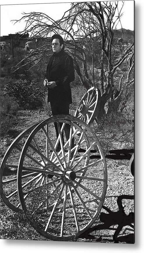 Johnny Cash Meditating Wagon Wheel Graveyard Old Tucson Az Black And White Metal Print featuring the photograph Johnny Cash meditating wagon wheel graveyard Old Tucson Arizona 1971 by David Lee Guss