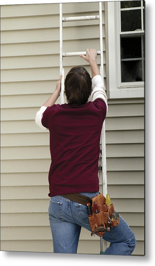 Three Quarter Length Metal Print featuring the photograph Man climbing ladder by Comstock Images