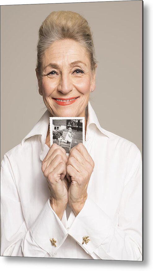 People Metal Print featuring the photograph Senior woman holding photo of her younger self by Compassionate Eye Foundation
