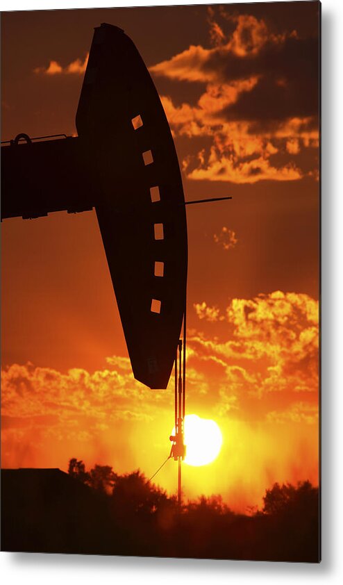 Oil Rig Metal Print featuring the photograph Oil rig pump jack silhouetted by setting sun #1 by Mark Duffy
