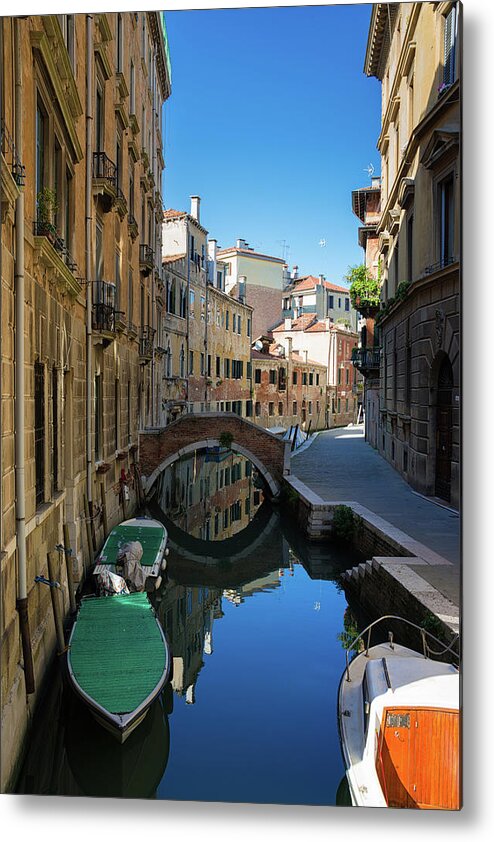 Venice Metal Print featuring the photograph Canal with boats and blue water in lovely Venice Italy by Matthias Hauser