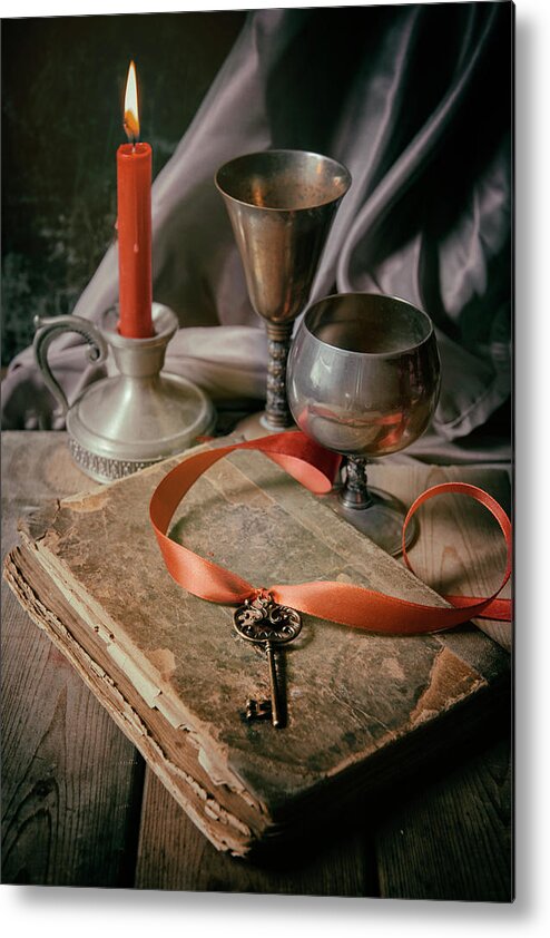 Lit Metal Print featuring the photograph Still life with old book and metal dishes by Jaroslaw Blaminsky