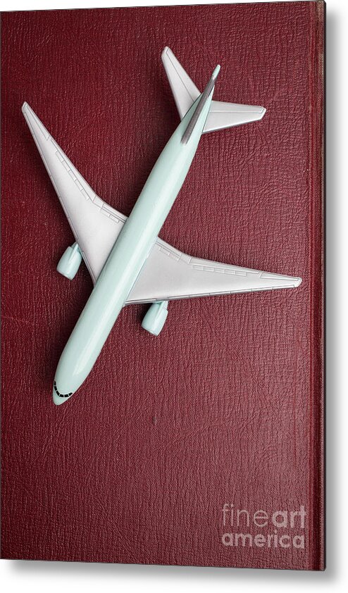 Still Life Metal Print featuring the photograph Toy Airplane over Red Book Cover by Edward Fielding