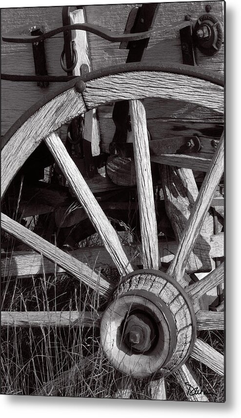 Wagon Metal Print featuring the photograph Weathered Wagon Wheel by Peggy Dietz