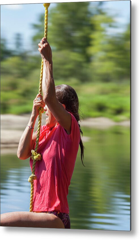 A Woman On A Rope Swing Over A River Metal Print by Woods