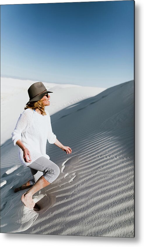 Hiker Metal Print featuring the photograph Hiker Climbing On Desert At White Sands National Monument During Sunny Day by Cavan Images