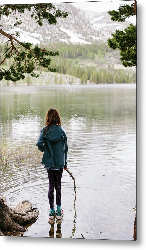 Girl Metal Print featuring the photograph Rear View Of Girl With Stick Standing In Lake At Inyo National Forest by Cavan Images