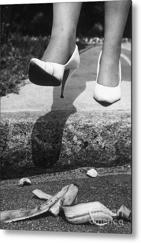People Metal Print featuring the photograph Woman In Heels Stepping On Banana Peel by Bettmann