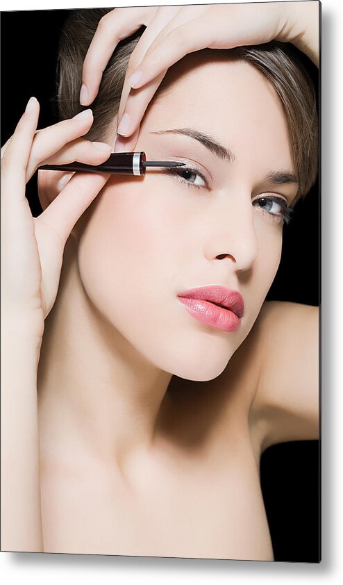 People Metal Print featuring the photograph Woman applying eyeliner #1 by Image Source