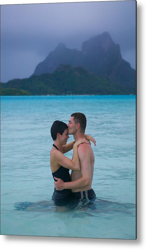 Heterosexual Couple Metal Print featuring the photograph A Caucasian Couple Embrace In The Shallow Water At A Tropical Beach by Photodisc