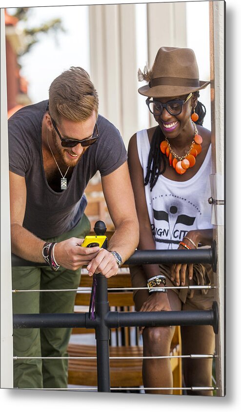 Young Men Metal Print featuring the photograph Couple using cell phone by Adam Hester