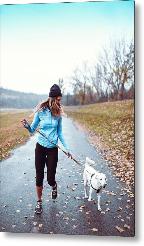 Domestic Animals Metal Print featuring the photograph Female Athlete Running With Dog In Park by AleksandarGeorgiev